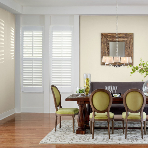 Custom composite shutters installed in a residential dining room. 