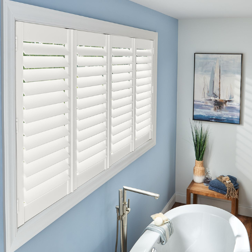 Vinyl shutters installed in a residential bathroom window. 
