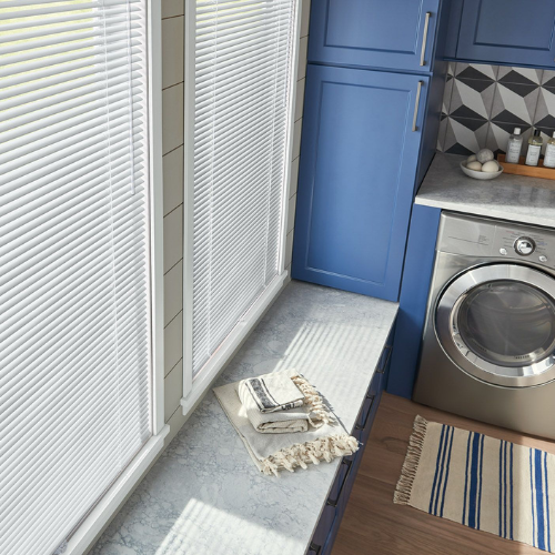 Metal blinds installed in a high-end, residential laundry room.