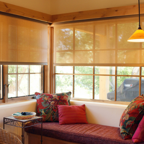 Custom roller shades installed in a living room