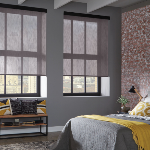 Solar shades installed in a bedroom to filter light and reduce glare. 