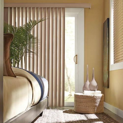 Vertical blinds installed over a sliding door in a residential bedroom. 