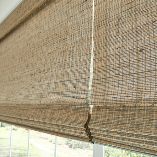 Woven shades made of natural fibers, installed in a residential kitchen.