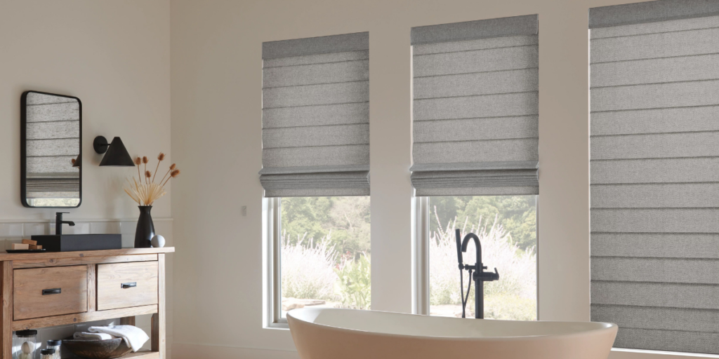 Custom roman shades installed in a residential bathroom. 