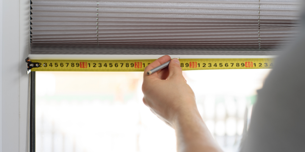 Blinds and window covering repair experts working on window shades. 