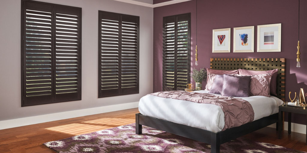 Custom plantation shutters in a St. Louis bedroom.