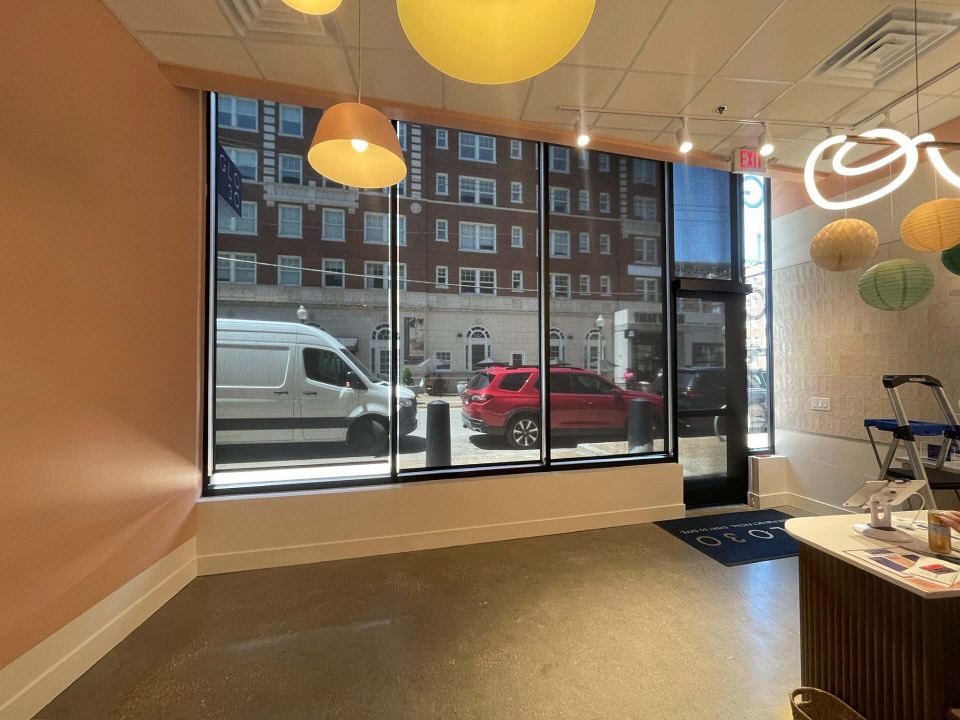 Custom commercial roller shades installed in a St. Louis retail storefront to reduce glare and improve comfort.