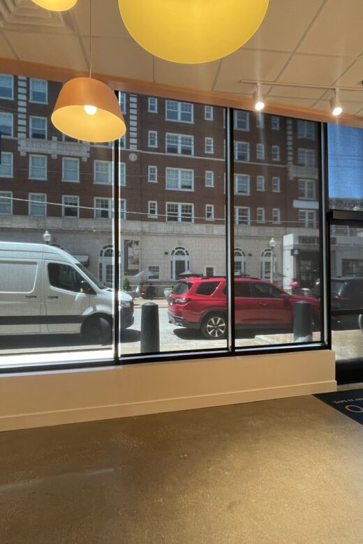 Custom commercial roller shades installed in a St. Louis retail storefront to reduce glare and improve comfort.