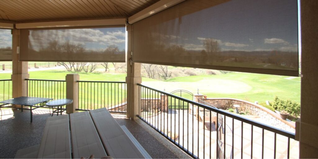 Patio shades installed in an outdoor dining space.
